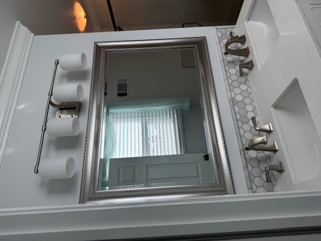 granite countertops, mirror, two bathroom sinks